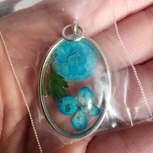 Silver toned pendant with flowers